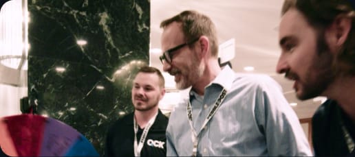 QCK team talking with attendees at a conference